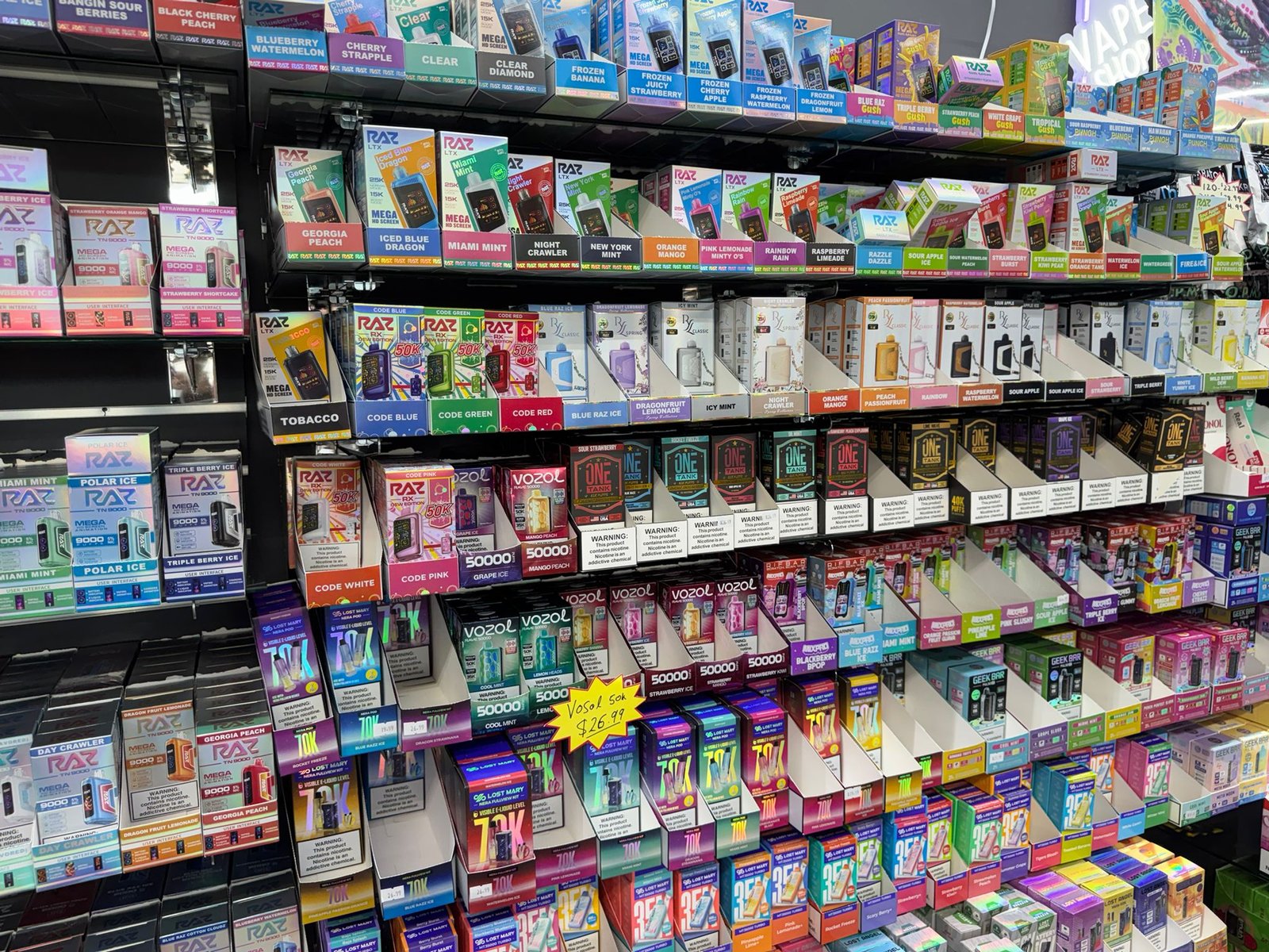 Massive Raz and Geek Bar vape wall at Local Store Smoke Shop St Petersburg FL — lowest prices $16.99